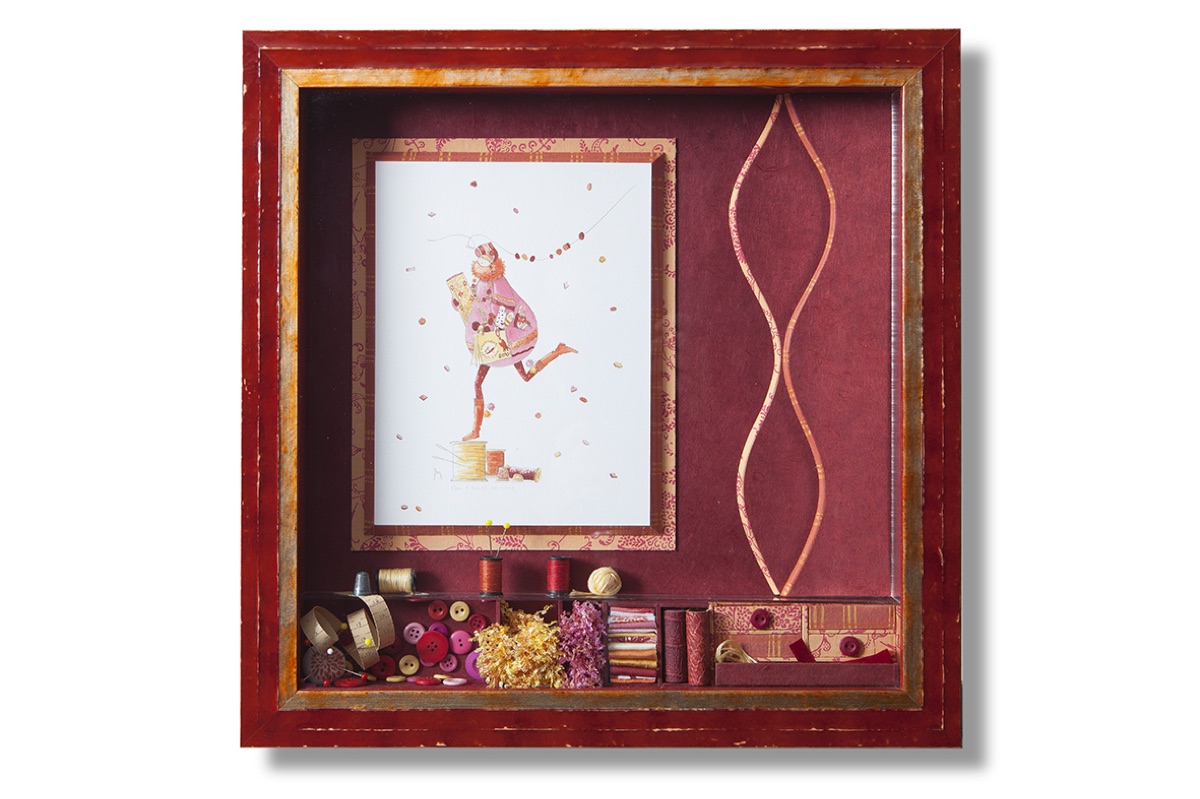 Illustration encadrée en vitrine rouge avec bobines, boutons et rubans